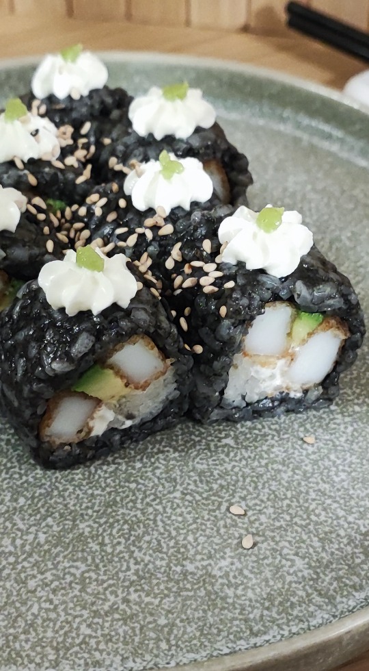 Weekly Premium: Black Rice Squid Ink Roll with Squid, Wasabi, and Cream Cheese This week's premium offering: black rice sushi with squid ink, squid, wasabi, and cream cheese.